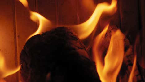 Close-up-shot-Burning-Flame-At-Fireplace-on-wooden-logs