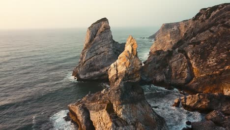 Aerial-view-of-the-major-central-rock-at-Ursa-Beach,-Sintra,-Portugal