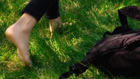 Girl's-feet-walking-through-grass-in-slow-motion