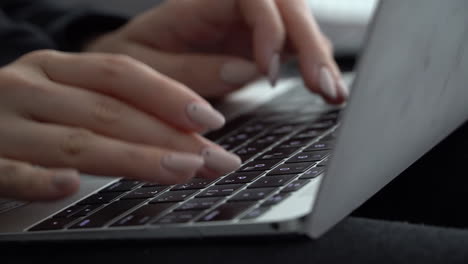 Female-hands-press-keys-on-the-keyboard-of-a-MacBook-with-a-Russian-layout