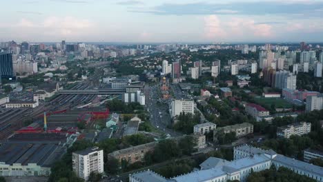 Aerial-View-of-Skyline-of-Kyiv,-Ukraine-With-Railroad-Tracks-and-Busy-Streets-in-View