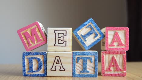Metadata---educational-toys,-cubes-with-letters,-placed-together-to-make-word-METADATA