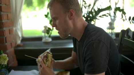 Man-enjoys-eating,-tasting-the-delicious-big-burger-meat