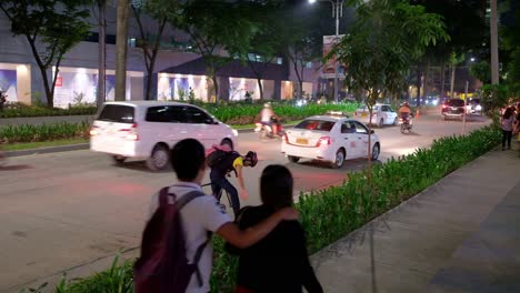 Outdoor-evening-scene-showing-vehicular-and-pedestrian-traffic-around-a-commercial-district-in-progressive-Cebu-City,-Philippines