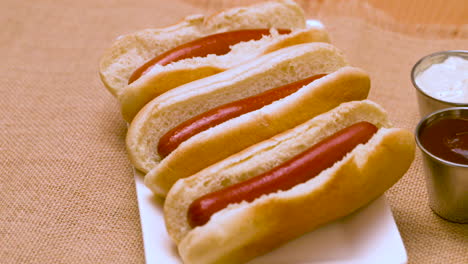Serving-of-hot-dogs-with-condiments-on-the-side