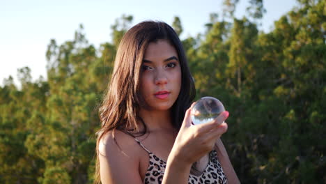 A-beautiful-enchanting-hispanic-woman-in-a-mystical-fantasy-world-with-a-magic-crystal-ball-and-a-sensual-stare