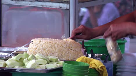 Seller-Bagging-up-Some-Sticky-Rice-in-Stall-at-Market