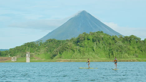 Shot-of-2-girls-paddling-on-Arenal-Lake-in-Costa-Rica
