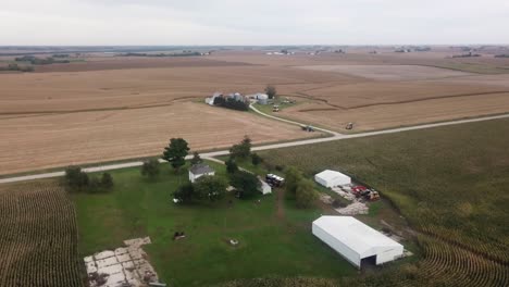 Aerial-drone-view-in-rural-Iowa-with-a-farm-with-barns-and-corn-fields