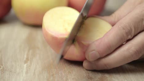 Slicing-a-juicy-red-and-yellow-apple-with-a-sharp-knife