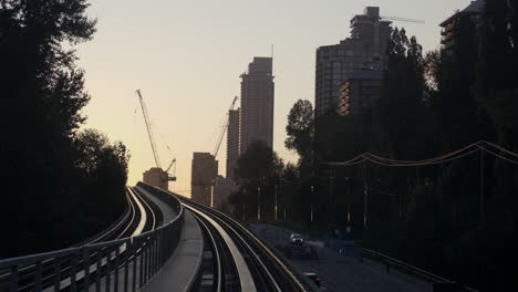 The-Beautiful,-Captivating-Sunrise-View-Of-Vancouver-City-Travelling-From-The-Famous-Millennium-Line---Medium-Shot
