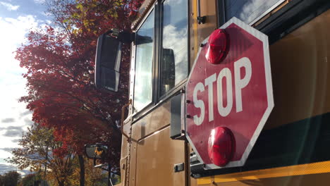 School-bus-stop-sign-autumn-trees-back-to-school