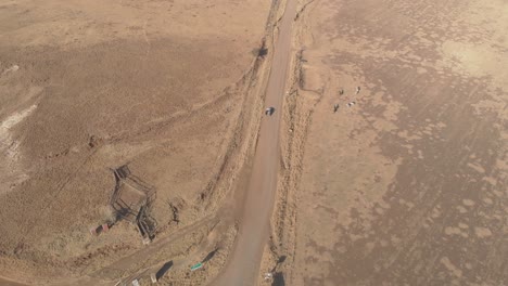 aerial-shot-following-a-pickup-truck-on-a-gravel-road