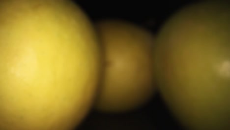 Pulling-away-from-3-apples,-one-on-the-left-is-lit-and-focused-while-other-2-are-in-the-shadows
