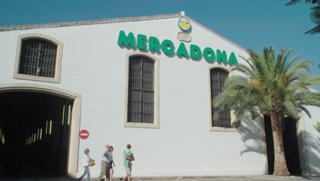 Mercadona-Supermarket-Buiding-Exterior-with-People-Walking-Out,-Spain