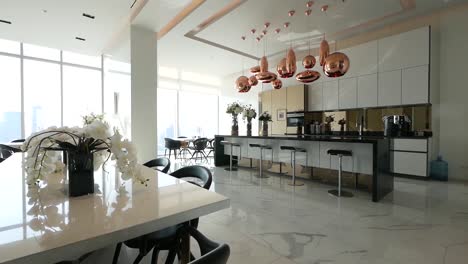 Fully-Decorated-Kitchen-Area-with-Counter-Bar,-Dinning-Area-and-Stools