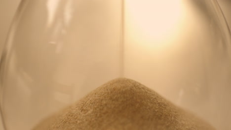 Hourglass-sand-falling-in-slow-motion-close-up