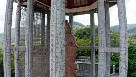 Kuan-Yin-Goddess-of-Mercy-Statue-located-in-Kek-Lok-Si-Buddhist-temple,-Aerial-drone-orbit-detail-shot