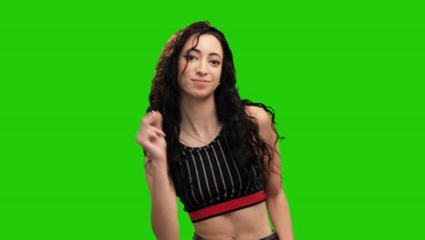 Cheerful-long-curly-haired-girl-dancing-on-green-screen-background