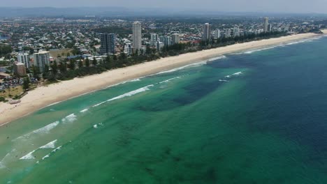 Spectacular-aerial-view-of-Burleigh-to-Broadbeach,-Summers-day,-waves-breaking-on-golden-beaches,pan