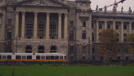 Yellow-Tram-Passing-By-Kossuth-Lajos-Square-In-Front-Of-Ethnographic-Museum-In-Budapest-Hungary---Panoramic-Shot