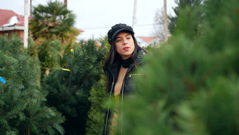A-woman-shopping-for-holiday-decorations-on-a-Christmas-tree-farm-lot