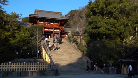 People-walking-up-the-stairs-made-of-stone,-Tsurugaoka-hachimangu-shrine,-Kamakura,-Japan