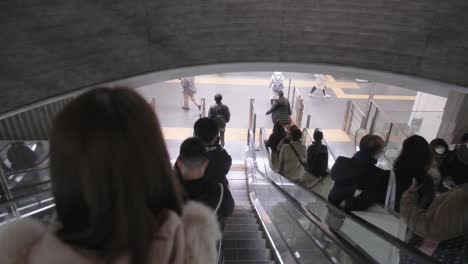 Japanese-commuters-on-escalator-standing-on-left-going-down-to-subway-platform