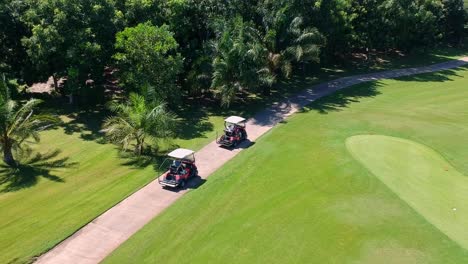 Tourist-Enjoy-Driving-Golf-Cart-Around-The-Field-On-A-Sunny-Day---Aerial-Shot