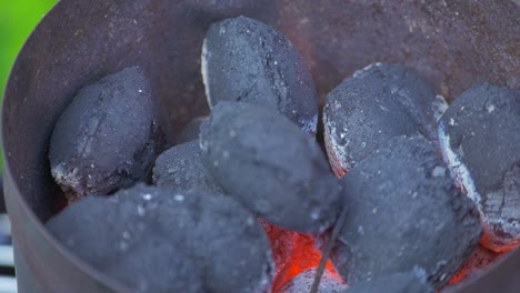 Hot-glowing-coals-laying-on-top-of-each-other-in-a-metal-container