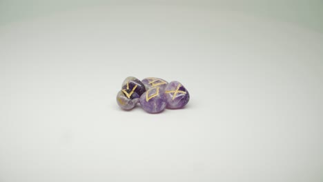 Expensive-Purple-Stone-With-Different-Yellow-Mark-On-The-Top-Rotating-On-The-Table---Close-Up-Shot
