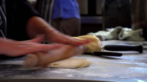 A-patissier-beats-and-moulds-a-clump-of-dough-and-then-begins-to-roll-out-with-a-rolling-pin