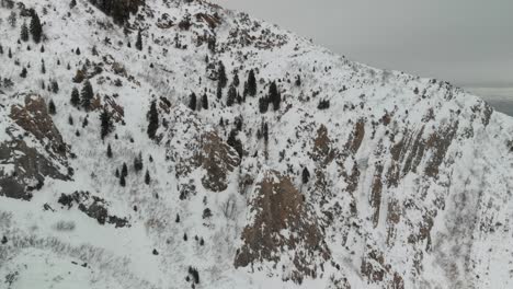 Aerial-fly-over-near-snow-covered-Grandeur-Peak-in-Utah