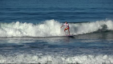 Male-surfing-ocean-waves-alone,-falls-into-water-failing---falling-off-surfboard