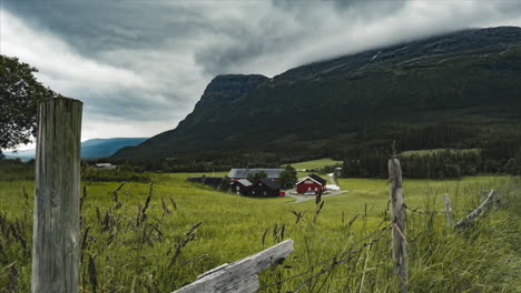 Red-Barn-And-Farmhouse-Built-By-The-Mountains-Of-Hemsedal-Norway---timelapse-shot
