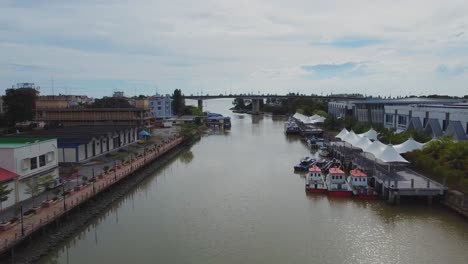 Slow-aerial-forward-shot-over-malacca-river-with-boats-during-daytime-in-Malaysia