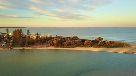 Drone---Aerial-view-of-a-turquoise-color-water-lagoon-at-the-golden-sunrise-sunset
