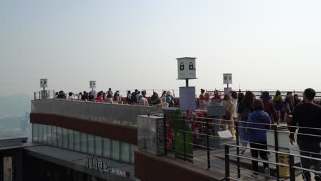 People-Tourists-take-pictures-on-Seoul-city-background-from-Namsan-mountain-N-tower-observation-deck-on-sunset
