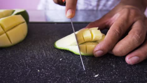 Man-cutting-mangoes-for-salad