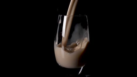 Delicious-creamy-hazelnut-milk-poured-into-a-glass-in-slow-motion
