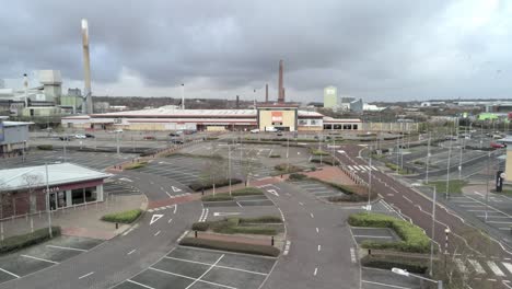 Aerial-view-deserted-retail-store-parking-areas-COVID-corona-virus-lockdown-low-dolly-left