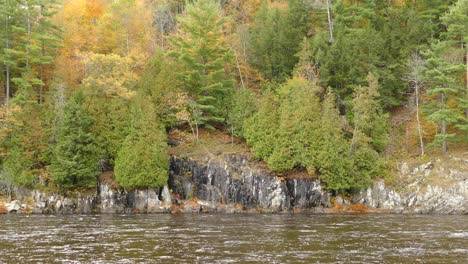 Dramatic-charcoal-colored-vertical-rocky-shores-of-a-river-during-autumn