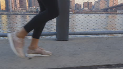 A-woman-running-along-the-East-River-at-sunrise-in-New-York