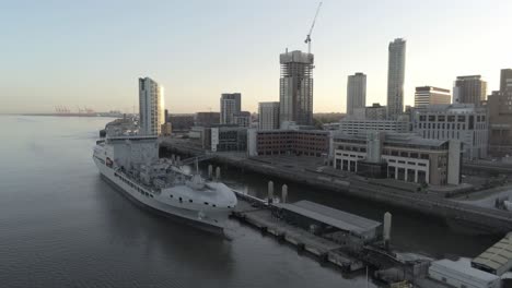 Liverpool-waterfront-aerial-view-royal-navy-military-ship-sunrise-high-rise-buildings-skyline