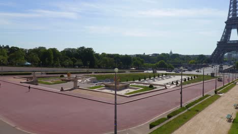 Trocadero-garden-and-fountain-during-sunny-morning-with-almost-nobody-and-eiffel-tower-in-the-back-in-Paris,-wide-panning-view