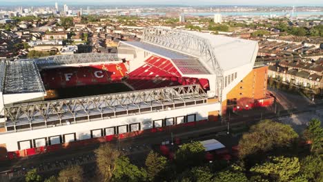 Iconic-Liverpool-Anfield-LFC-stadium-football-ground-aerial-view-slow-tilt-up-to-city-skyline