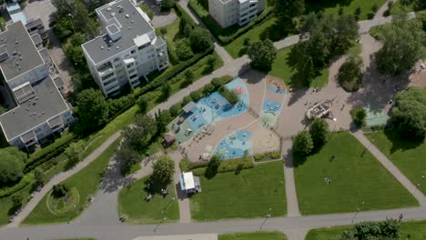 Top-down-aerial-view-of-a-colorful-playground-in-a-park,-Finland