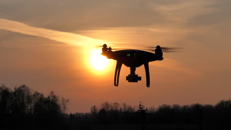 Flying-prosumer-drone-silhouette-during-sunset
