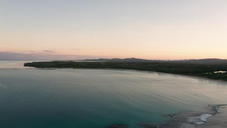 Natadola-Bay-in-Fiji-during-tranquil-sunrise,-aerial-pan-right