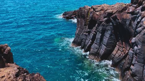 Ocean-waves-lap-volcanic-rock-coastline-in-Madeira